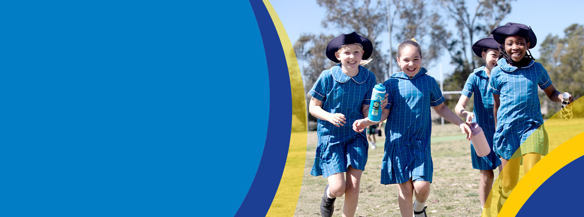 Students smiling together on the school oval at St Angela's Primary School Castle Hill
