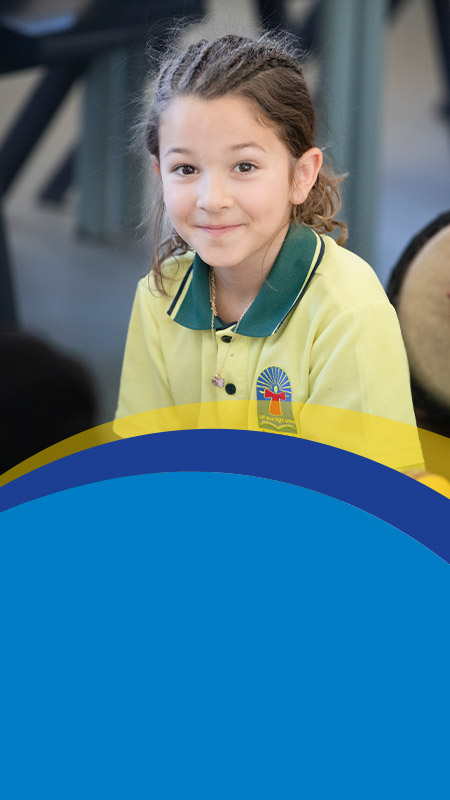 Student smiling in the classroom at St Angela's Primary School Castle Hill