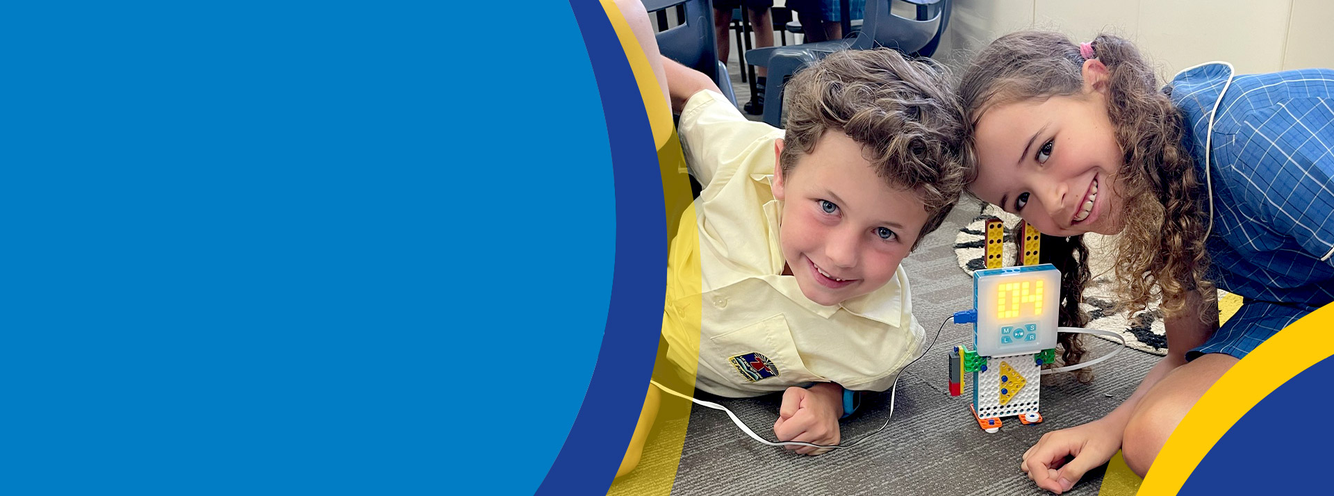 Students building a robot together in the classroom at St Angela's Primary School Castle Hill