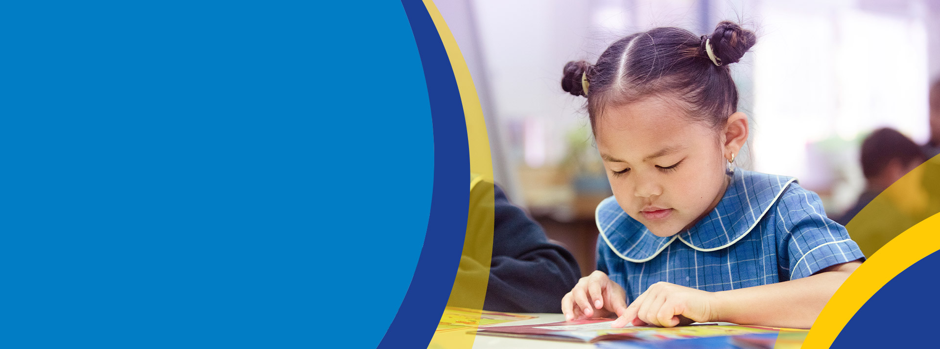 Student reading in the classroom at St Angela's Primary School Castle Hill