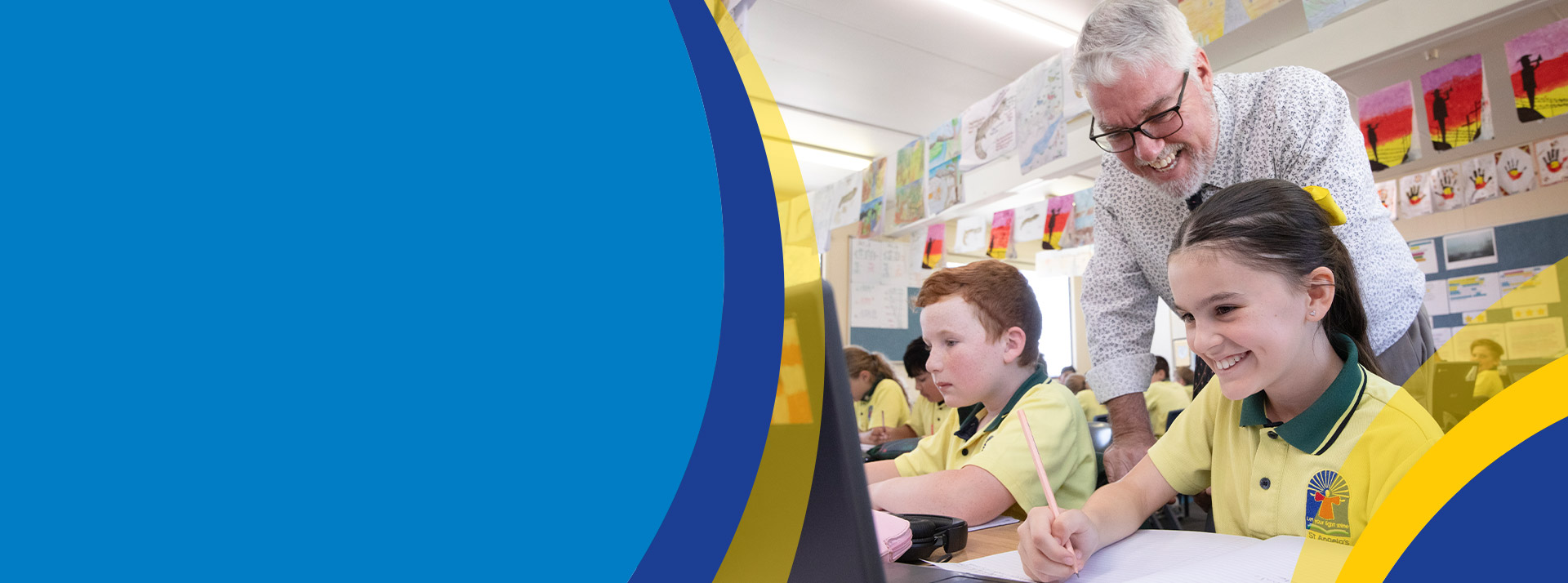 Teacher with his students in the classroom at St Angela's Primary School Castle Hill