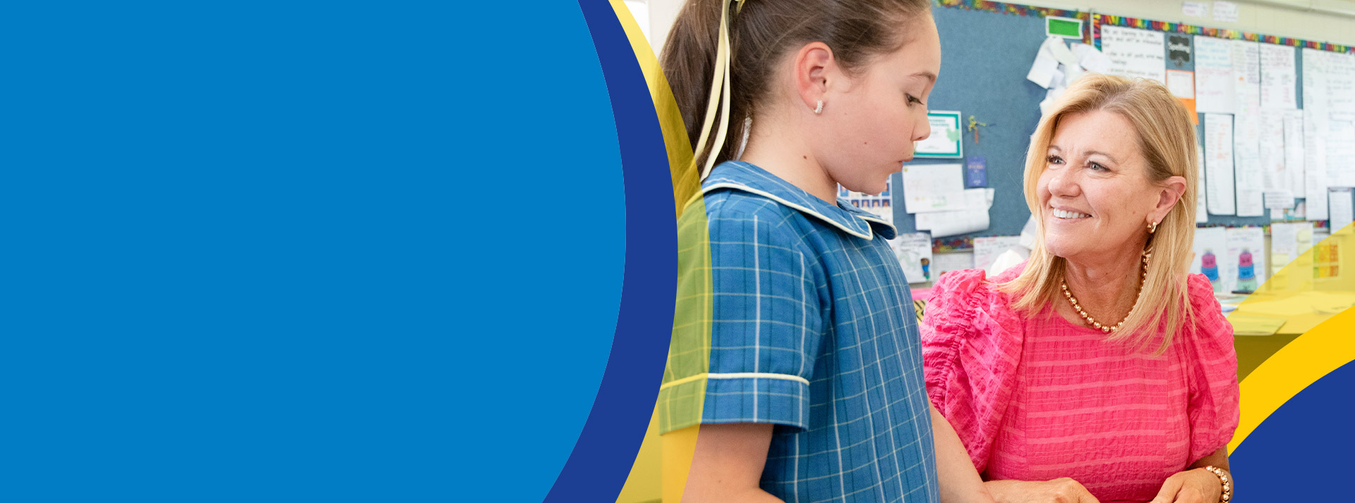 Teacher with her student in the classroom at St Angela's Primary School Castle Hill