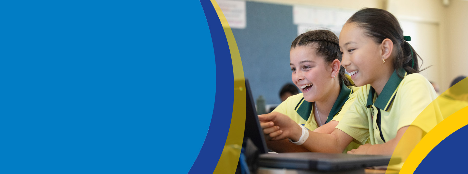 Students working on the laptop together in the classroom at St Angela's Primary School Castle Hill