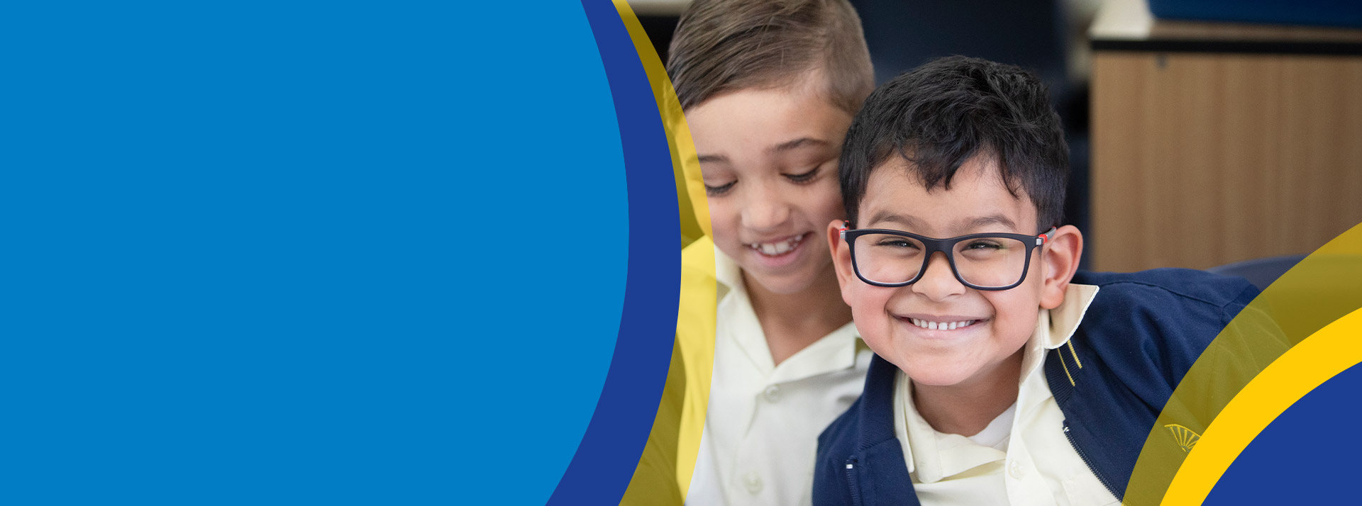 Student wearing glasses smiling in the classroom at St Angela's Primary School Castle Hill