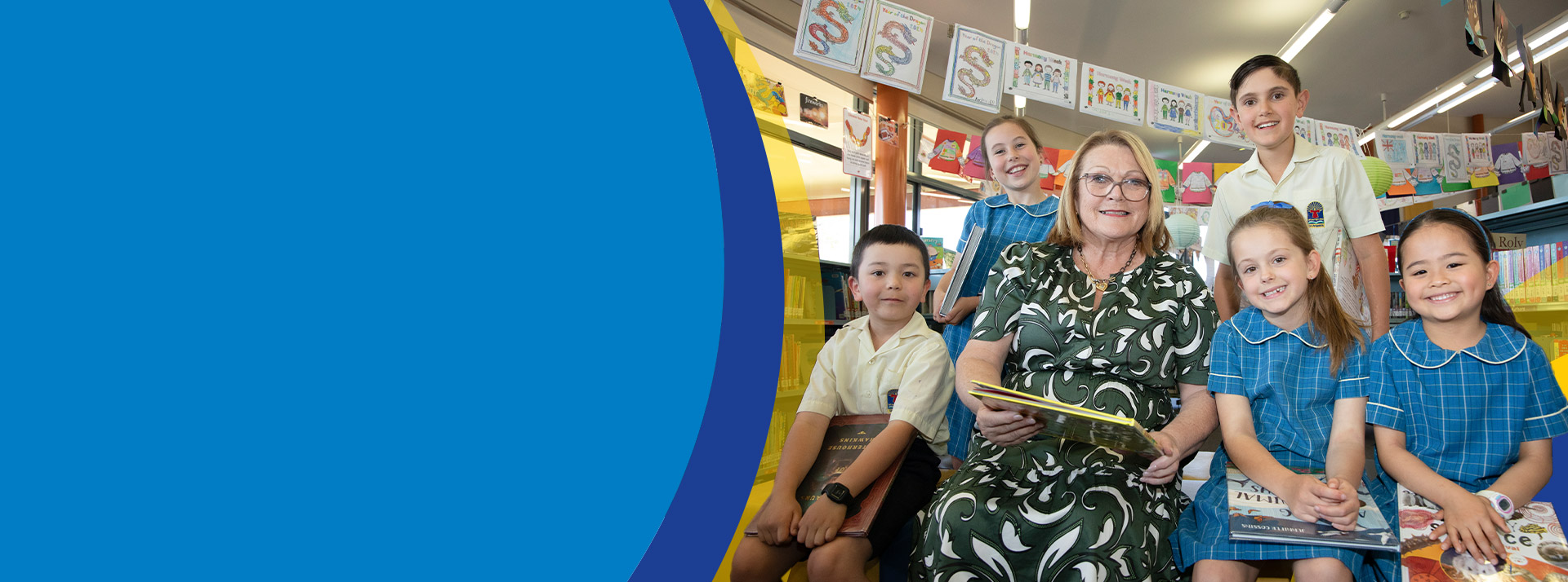 Principal Leanne Nettleton reading with students in the library at St Angela's Primary School Castle Hill