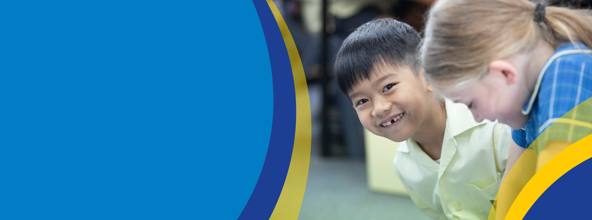 Student smiling in the classroom at St Angela's Primary School Castle Hill