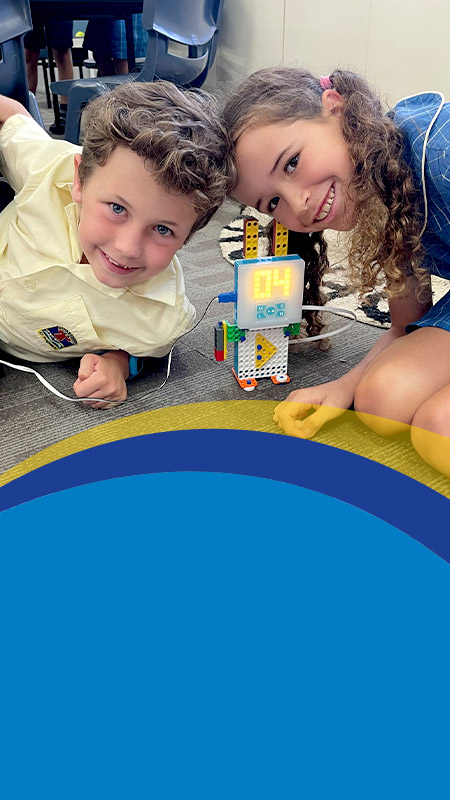 Students building a robot together in the classroom at St Angela's Primary School Castle Hill