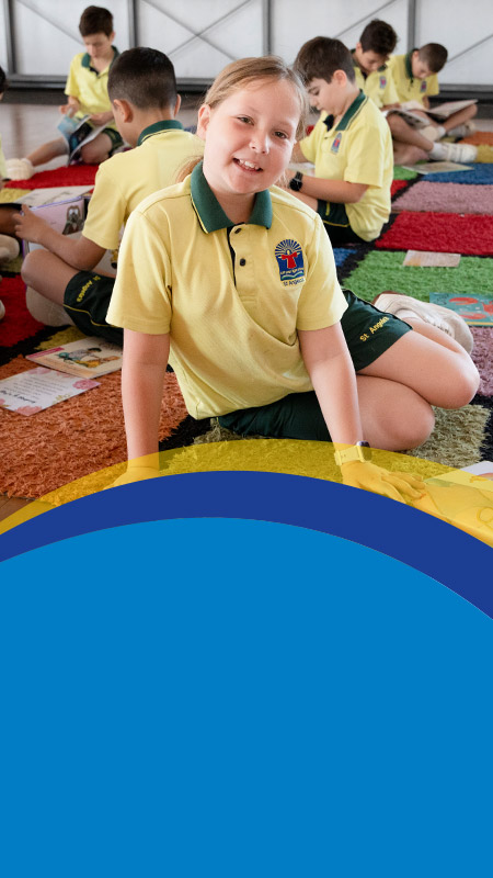 Student smiling in the classroom at St Angela's Primary School Castle Hill