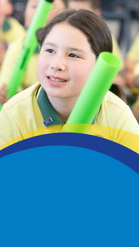 Student smiling in the classroom at St Angela's Primary School Castle Hill