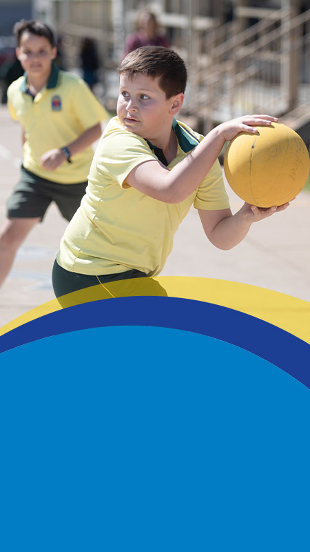 Students playing netball together on the playground at St John's Primary School Riverstone