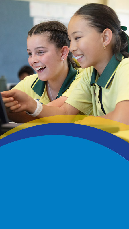 Students working together on the laptop in the classroom at St Angela's Primary School Castle Hill