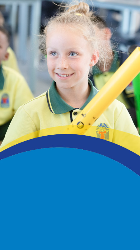 Student smiling in the classroom at St Angela's Primary School Castle Hill