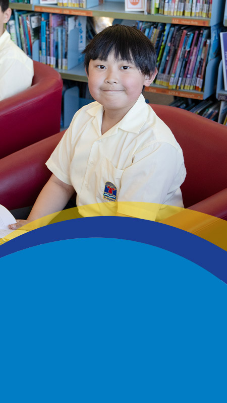 Students reading together in the library at St Angela's Primary School Castle Hill