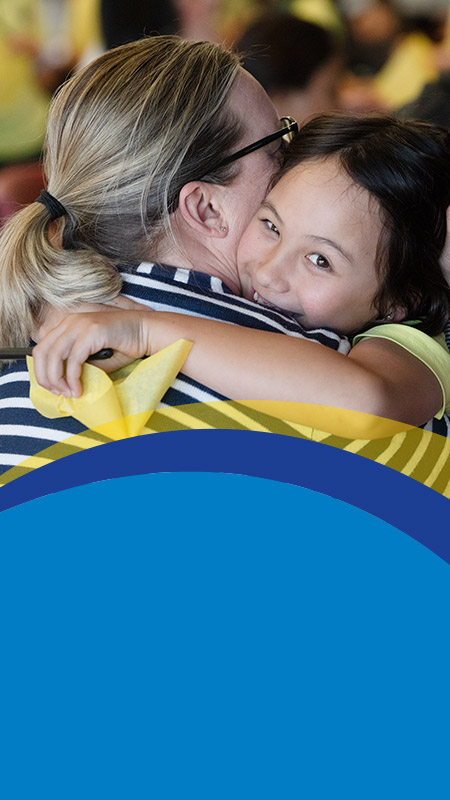 Student hugging her mum at St Angela's Primary School Castle Hill