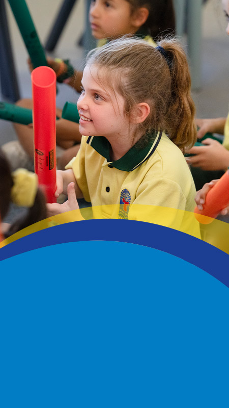 Students smiling together in the classroom at St Angela's Primary School Castle Hill