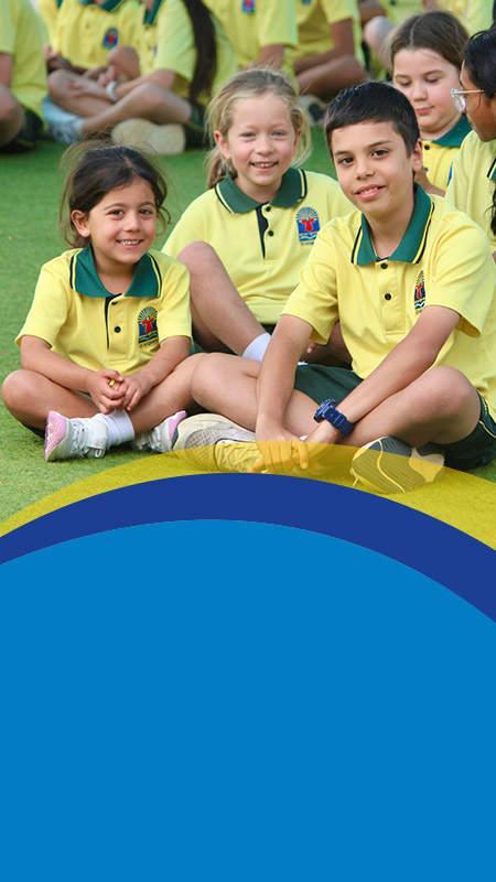 Students sitting together on the playground at St Angela's Primary School Castle Hill