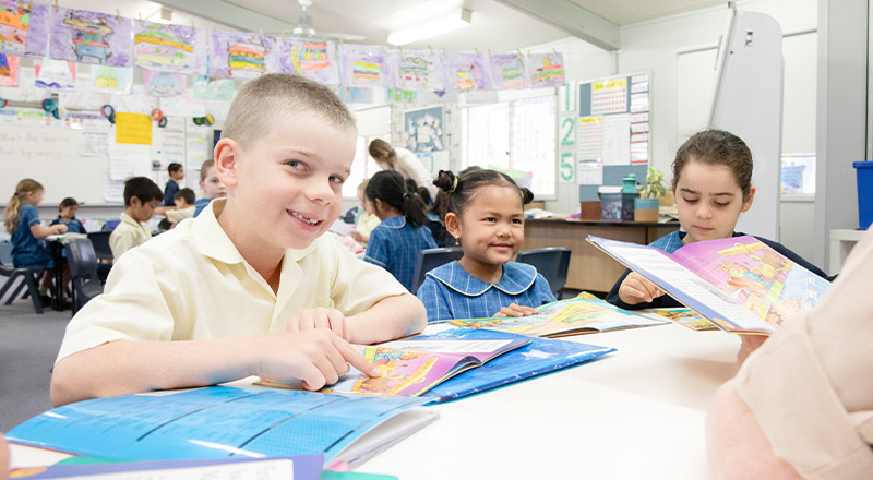 Students reading together in the classroom at St Angela's Primary School Castle Hill