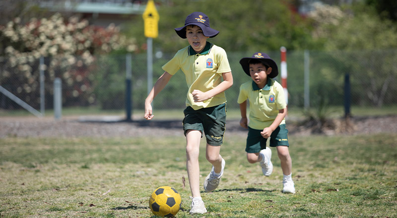 Students playing soccer outside at St Angela's Primary School Castle Hill