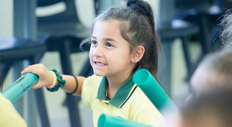 Student smiling in the classroom at St Angela's Primary School Castle Hill