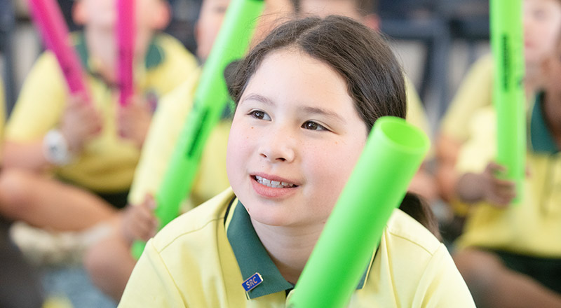 Student smiling in the classroom at St Angela's Primary School Castle Hill