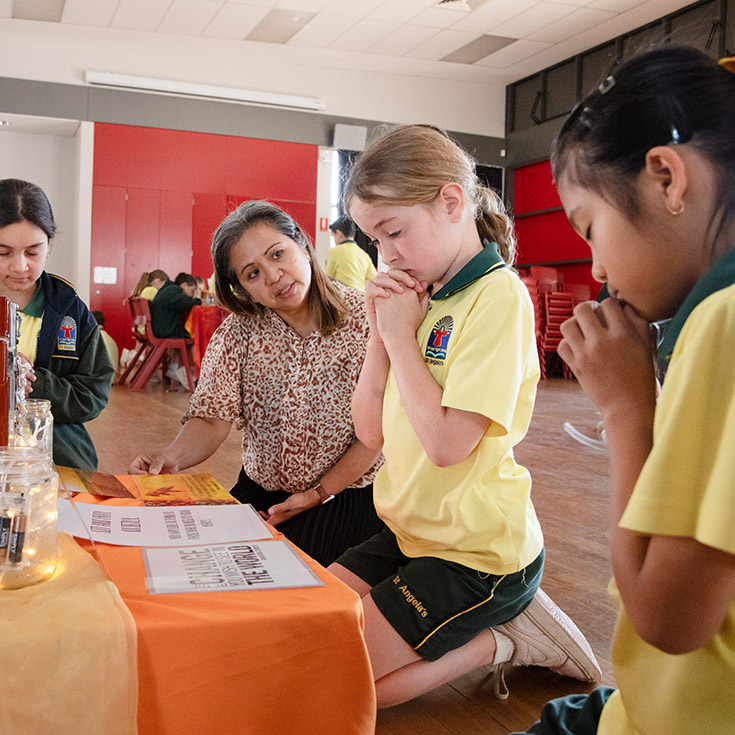 Students in prayer during class at St Angela's Primary School Castle Hill