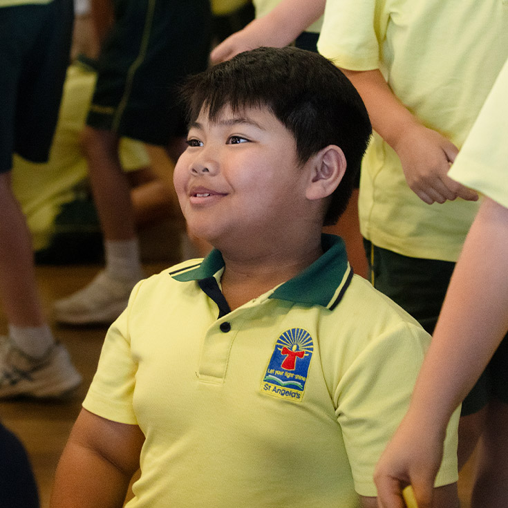 Student smiling in the classroom at St Angela's Primary School Castle Hill