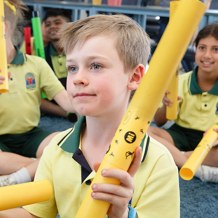 Student smiling in before and after care at St Angela's Primary School Castle Hill