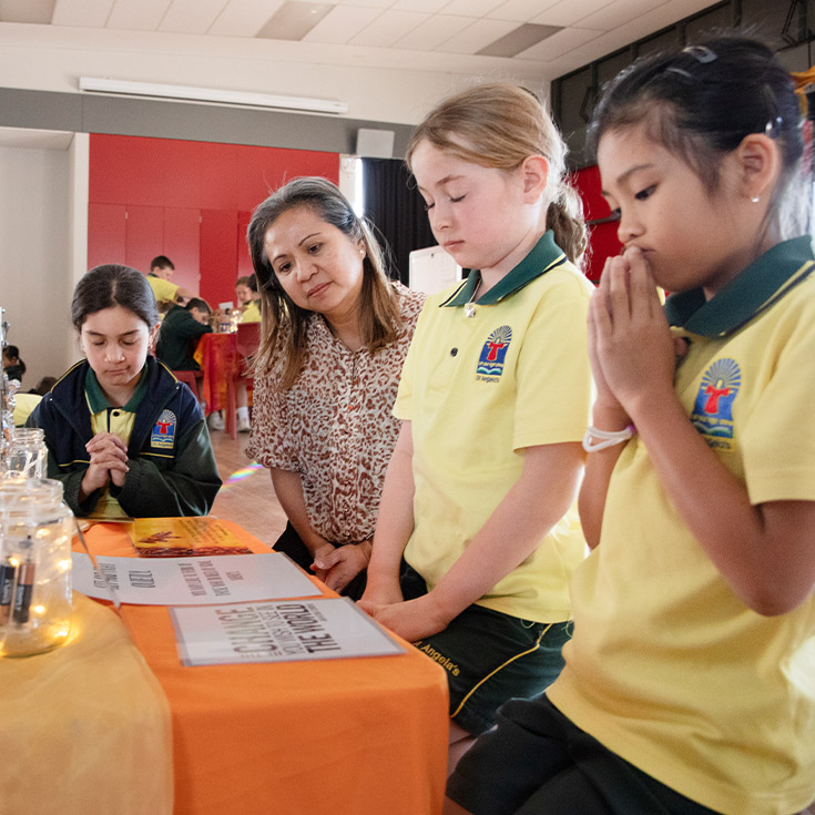 Teacher and her students reflecting in the prayer space at St Angela's Primary School Castle Hill