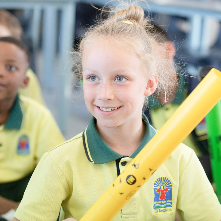 Student smiling in the classroom at St Angela's Primary School Castle Hill