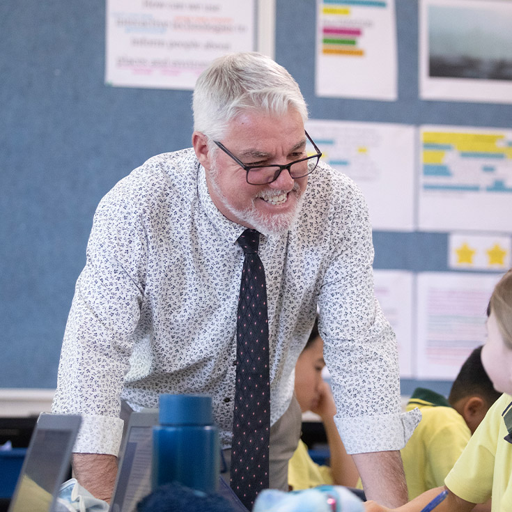 Teacher with his students in the classroom at St Angela's Primary School Castle Hill