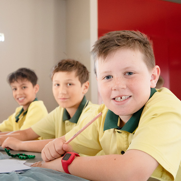 Students smiling in the classroom at St Angela's Primary School Castle Hill